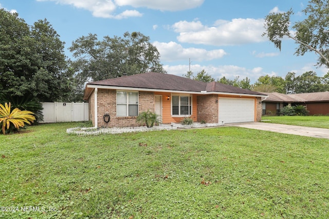 single story home featuring a front yard and a garage