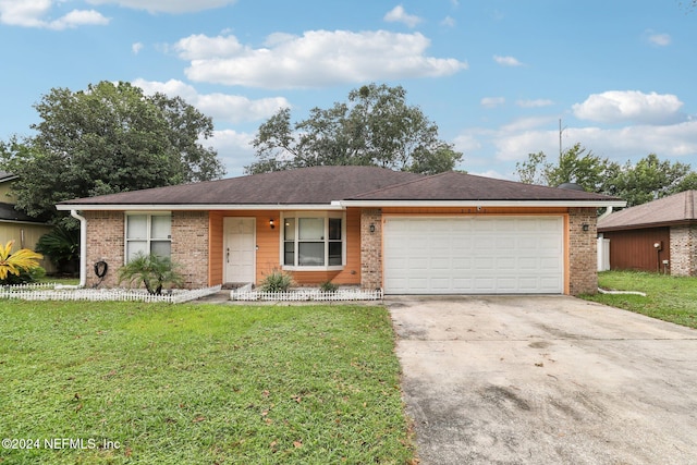 ranch-style home with a garage and a front lawn