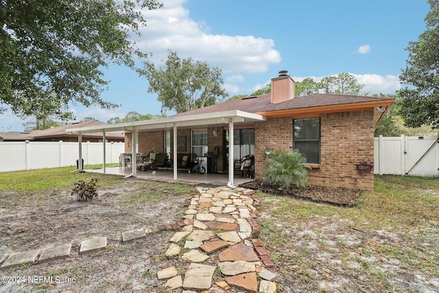 back of house with a patio