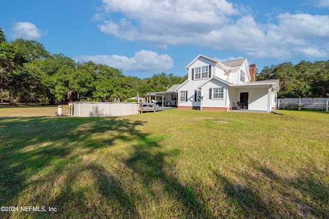 rear view of house with a lawn