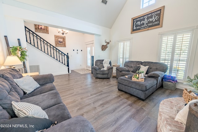 living room featuring hardwood / wood-style flooring, high vaulted ceiling, and a healthy amount of sunlight