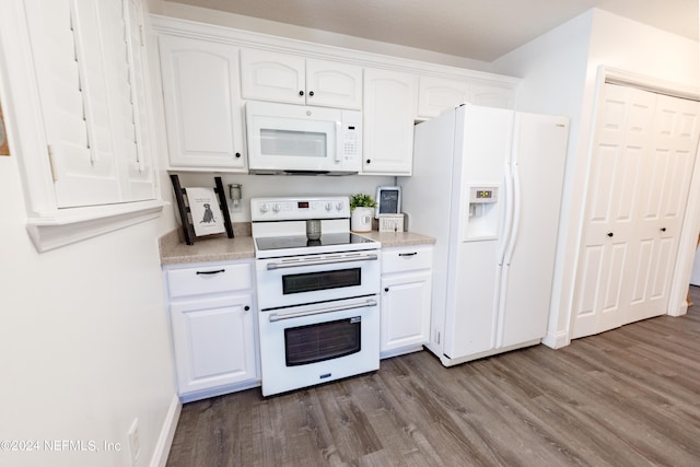 kitchen featuring hardwood / wood-style floors, white appliances, and white cabinetry