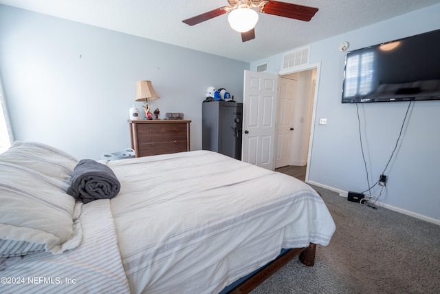 bedroom with dark carpet, a textured ceiling, and ceiling fan