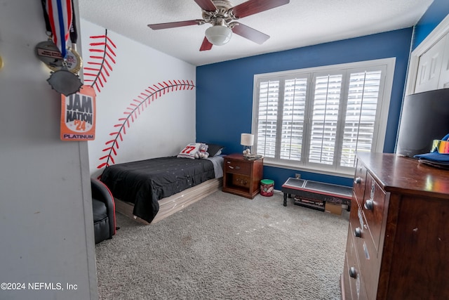 carpeted bedroom featuring a textured ceiling, multiple windows, and ceiling fan