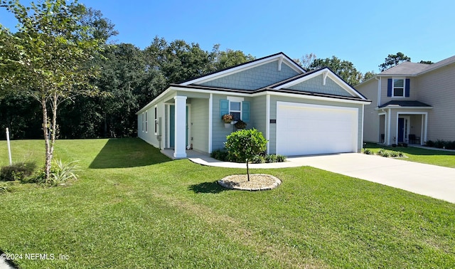 view of front of property featuring a front yard and a garage