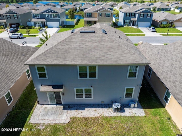 rear view of property with a yard and cooling unit