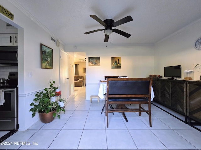 dining space featuring ornamental molding, ceiling fan, light tile patterned flooring, and a textured ceiling