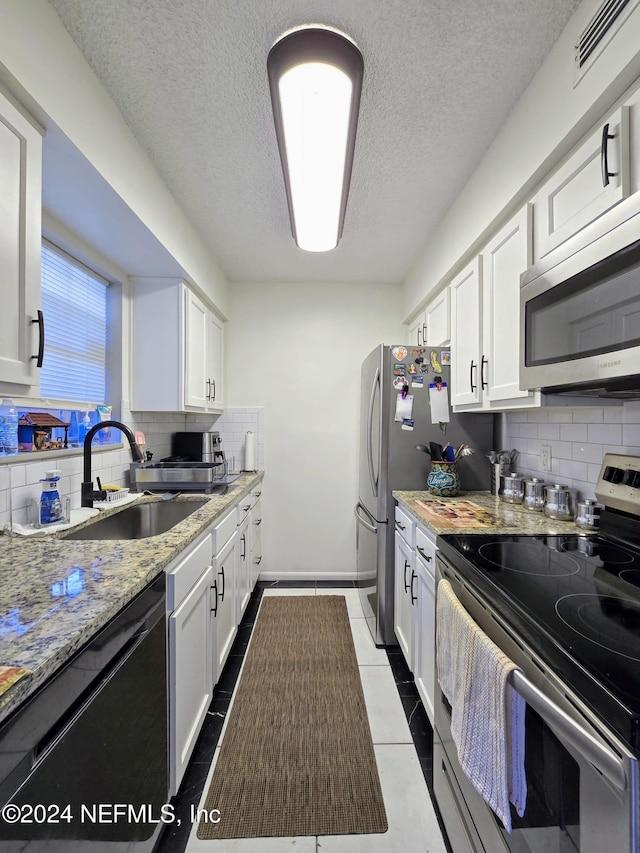 kitchen featuring white cabinets and appliances with stainless steel finishes