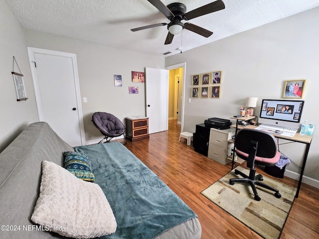 office with ceiling fan, hardwood / wood-style floors, and a textured ceiling