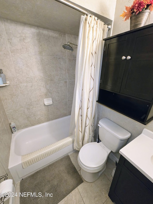 full bathroom with tile patterned floors, shower / bath combo, vanity, and toilet