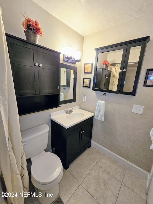 bathroom with vanity, toilet, and tile patterned floors