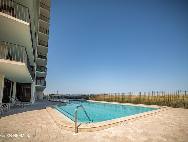 view of swimming pool with a patio