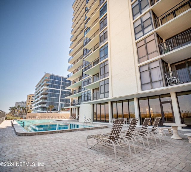 1301 1st St S Unit 1202, Jacksonville Beach, FL 32250 - community pool with a patio area