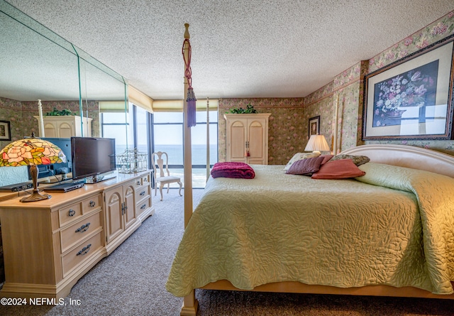 bedroom featuring carpet flooring and a textured ceiling