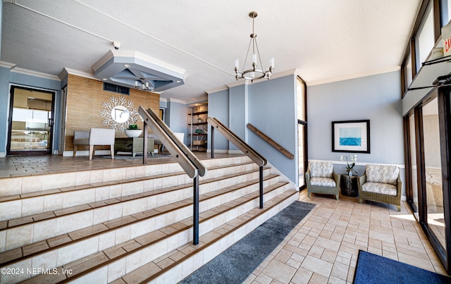 stairs featuring crown molding, a textured ceiling, and a chandelier