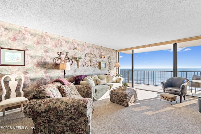 1301 1st St S Unit 1202, Jacksonville Beach, FL 32250 - living area featuring a water view, a wall of windows, carpet, a textured ceiling, and wallpapered walls