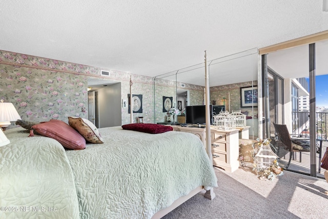 1301 1st St S Unit 1202, Jacksonville Beach, FL 32250 - bedroom with wallpapered walls, carpet flooring, access to exterior, and a textured ceiling