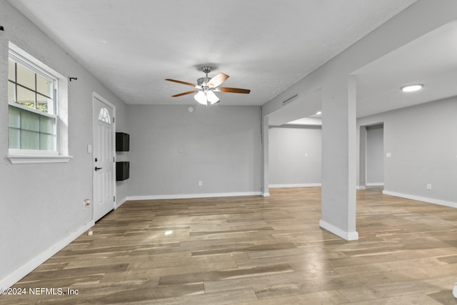 unfurnished living room with ceiling fan and hardwood / wood-style flooring