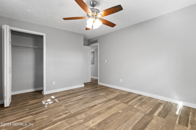 unfurnished bedroom with a closet, hardwood / wood-style floors, and ceiling fan