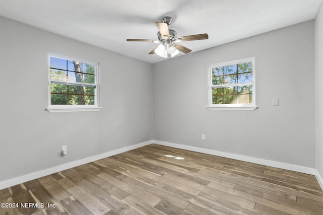 empty room with ceiling fan, hardwood / wood-style flooring, and a textured ceiling