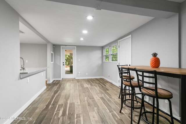 dining area featuring hardwood / wood-style flooring and indoor bar