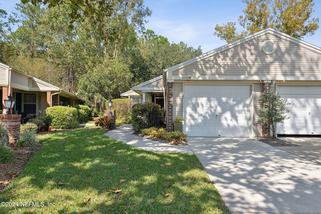 view of front of property with a front lawn and a garage