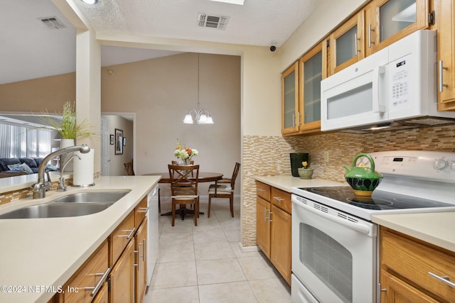 4508 Middleton Park Cir W, Jacksonville, FL 32224 - kitchen with tasteful backsplash, a sink, brown cabinets, white appliances, and visible vents