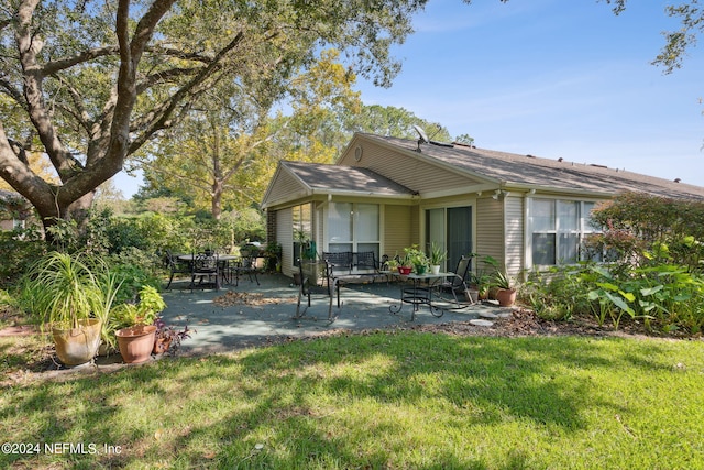 4508 Middleton Park Cir W, Jacksonville, FL 32224 - rear view of house featuring a patio area and a lawn