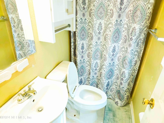 bathroom with vanity, toilet, and a shower with shower curtain