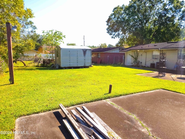 view of yard featuring a patio area and a storage shed