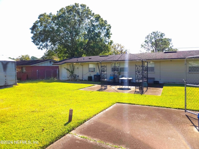 rear view of house with a yard, a patio area, and cooling unit