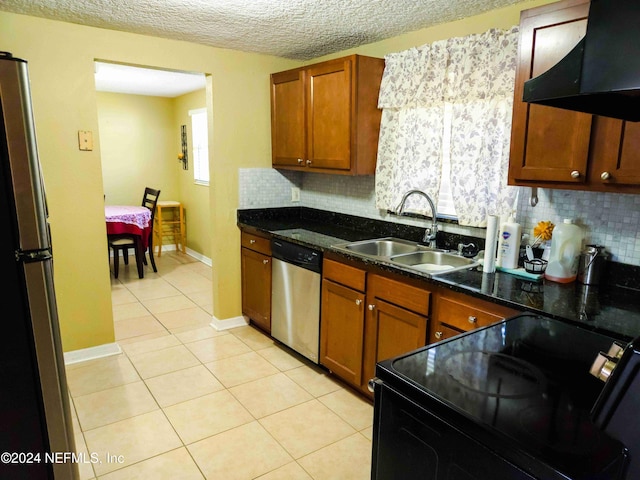 kitchen featuring decorative backsplash, appliances with stainless steel finishes, sink, and ventilation hood