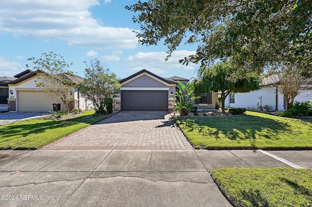 view of front of property with a garage and a front yard