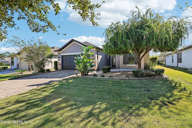 view of front of property with a garage and a front lawn