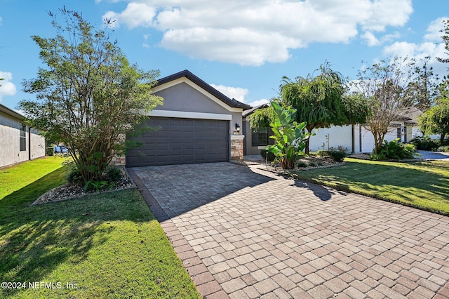 view of front of home with a garage and a front yard