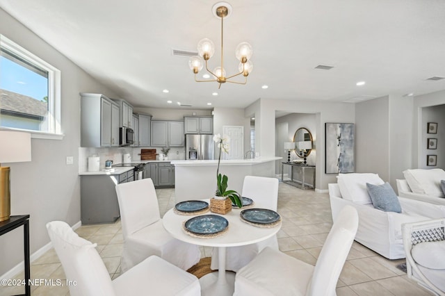 dining room featuring light tile patterned floors and a chandelier