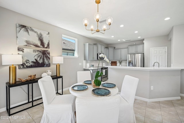 dining area with light tile patterned floors, a notable chandelier, and sink