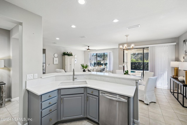 kitchen featuring stainless steel dishwasher, gray cabinetry, ceiling fan with notable chandelier, sink, and light tile patterned floors