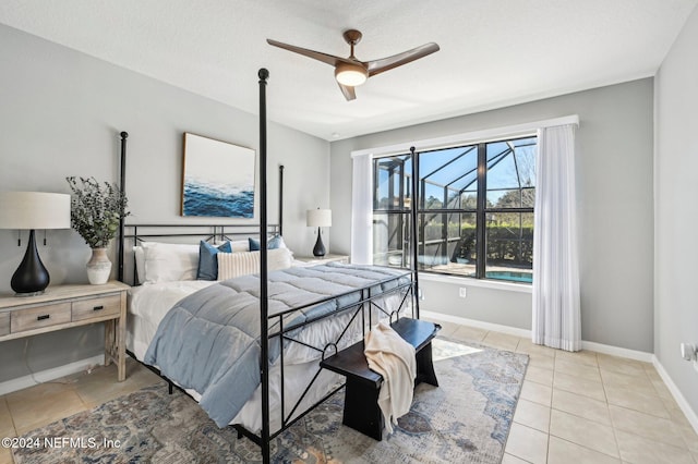 bedroom with ceiling fan, light tile patterned flooring, and a textured ceiling