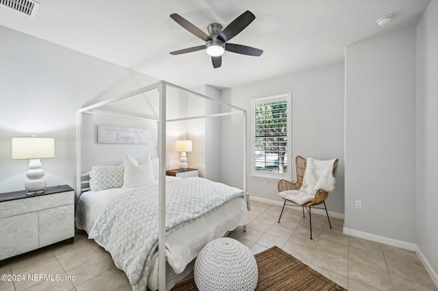 bedroom with ceiling fan and light tile patterned floors