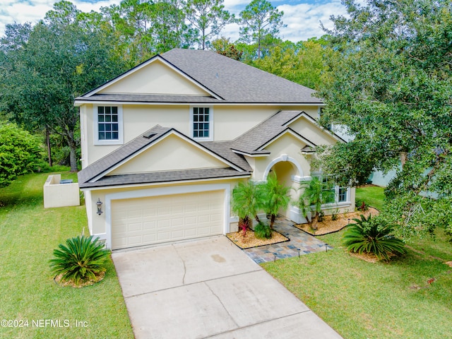 front facade featuring a front yard and a garage