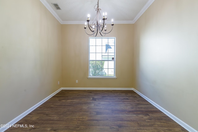 empty room featuring dark wood-type flooring, crown molding, and a chandelier