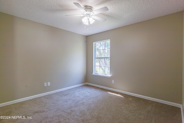 carpeted empty room featuring a textured ceiling and ceiling fan