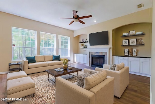 living room featuring wood-type flooring and ceiling fan