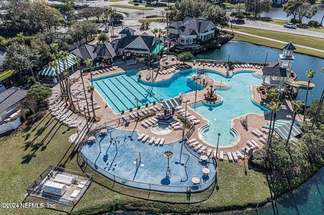 view of pool with a patio and a water view