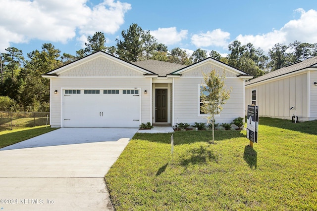 ranch-style home with a front lawn and a garage