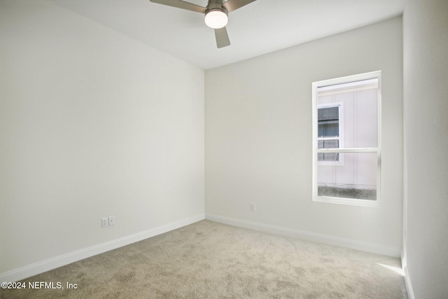 carpeted empty room featuring ceiling fan