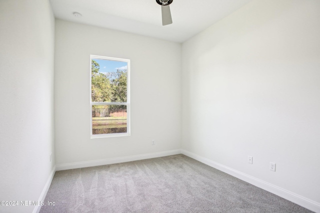 spare room featuring carpet and ceiling fan