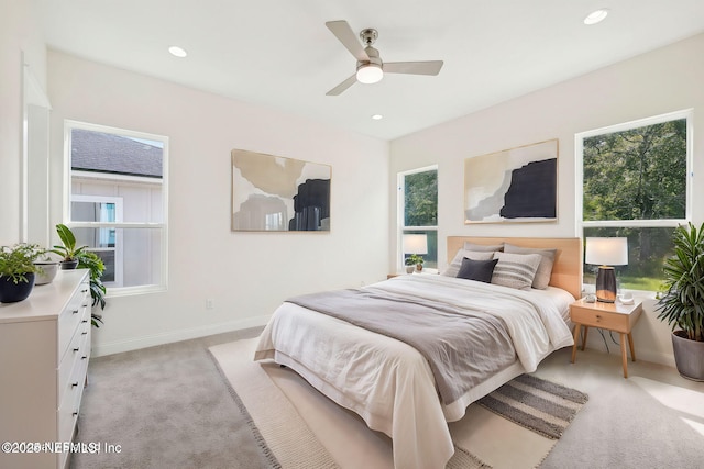 bedroom featuring light colored carpet and ceiling fan