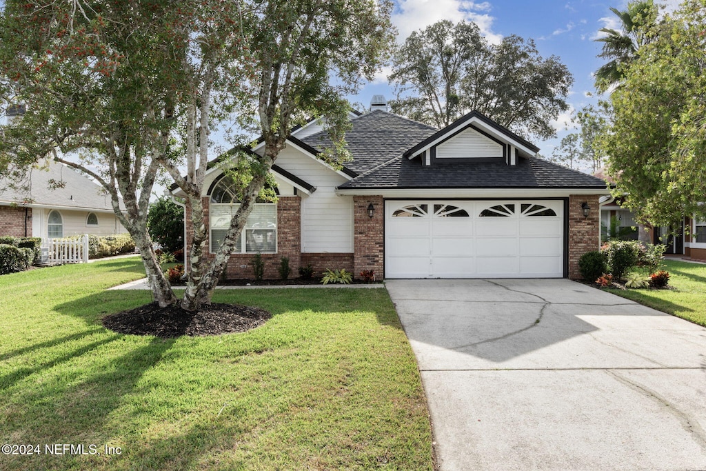 view of front facade with a front lawn and a garage